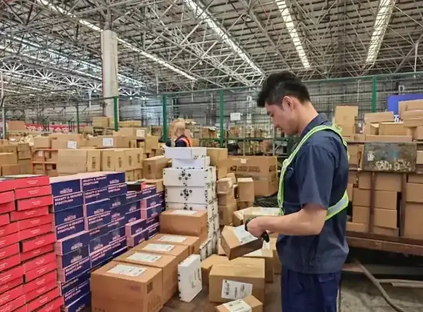 Warehouse worker scanning outbound parcels