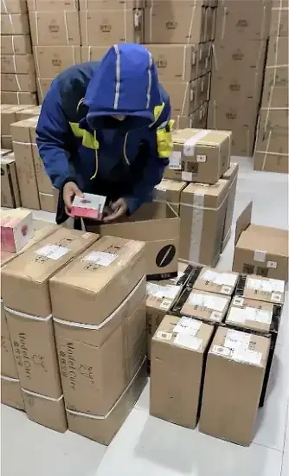 Worker packing cartons in the warehouse