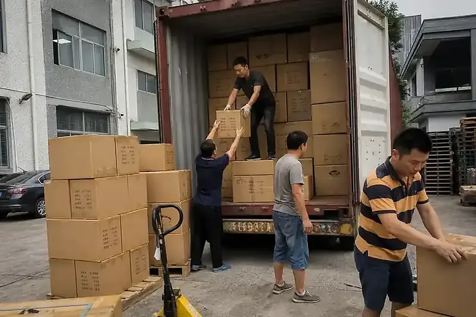 Stuffing cartons into an open shipping container